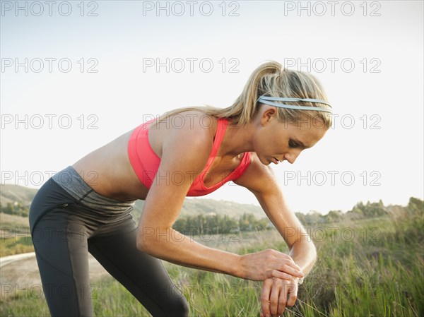 Caucasian woman taking her pulse after exercise