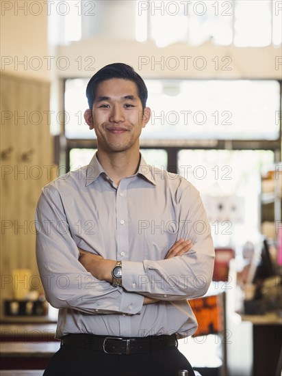 Smiling Chinese man posing in restaurant