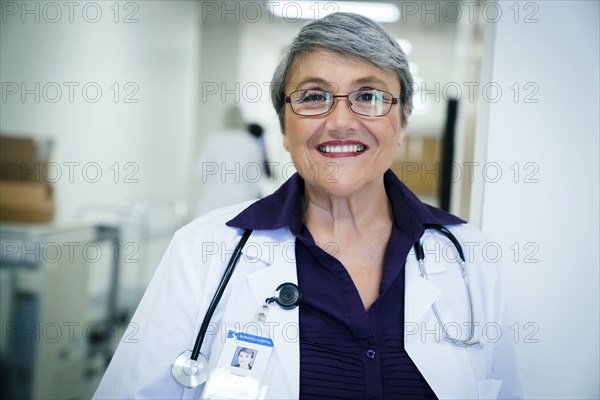 Portrait of smiling mixed race doctor