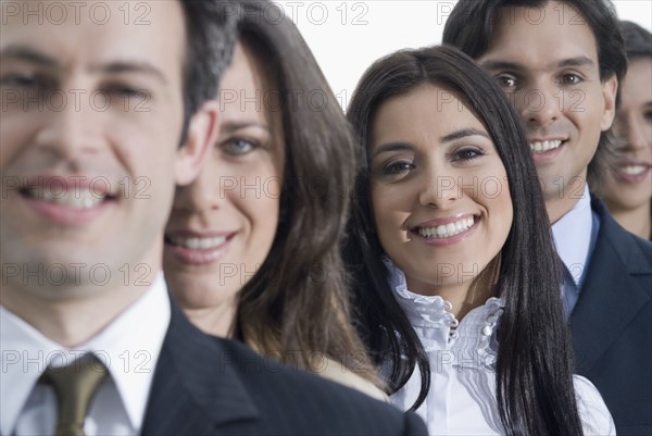 Hispanic co-workers standing in row