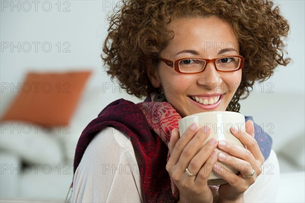 Hispanic woman drinking coffee