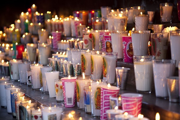 Rows of burning religious candles