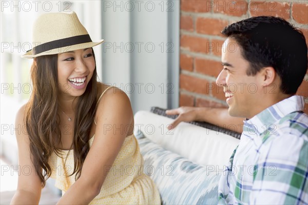 Couple laughing on porch