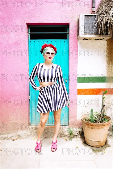 Caucasian woman standing by colorful building