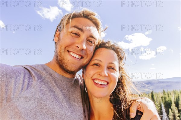 Caucasian couple hugging outdoors