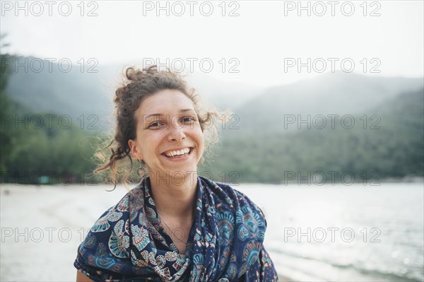 Smiling Caucasian woman at beach