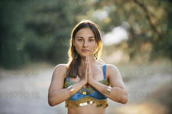 Caucasian Belly Dancer With Hands Clasped Photo12 Tetra Images Ivan Evgenyev