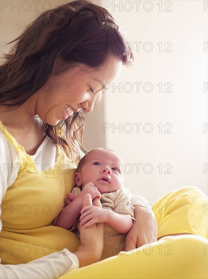 Mother holding newborn baby in her lap