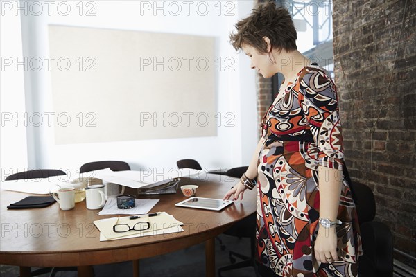 Pregnant businesswoman using digital tablet in office