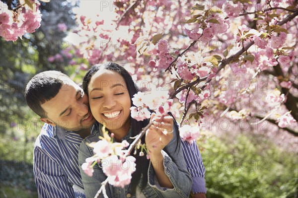 Couple admiring flowering tree in park