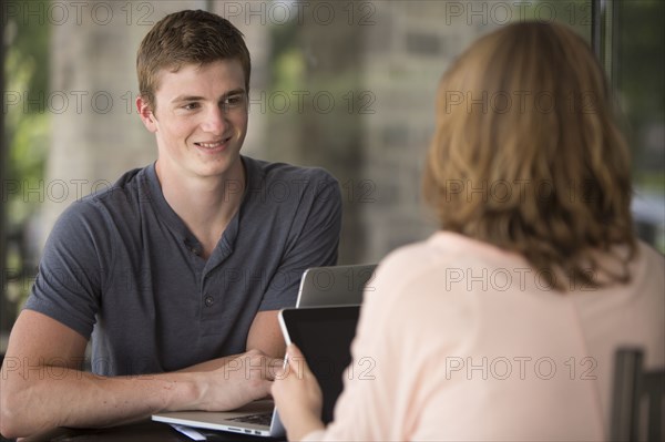 Caucasian students studying at table