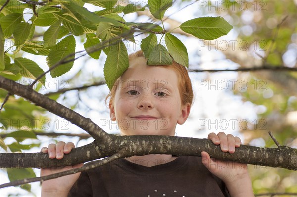 Portrait of Caucasian girl holding tree branch