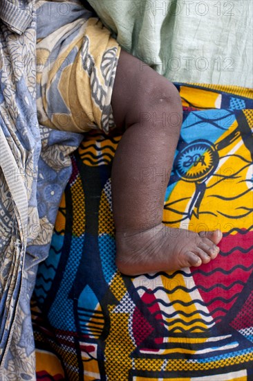 Close up of mother carrying baby with traditional wrap