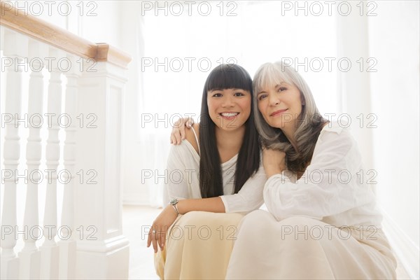 Mother and daughter hugging on steps