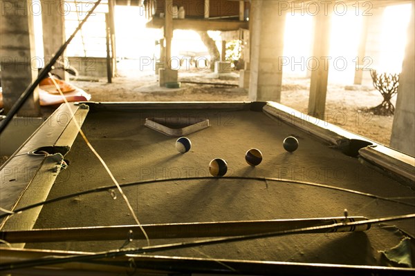 Fishing rods and pool cues on pool table