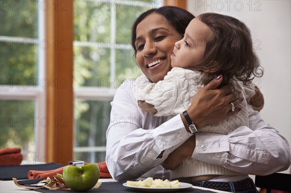 Indian mother hugging daughter