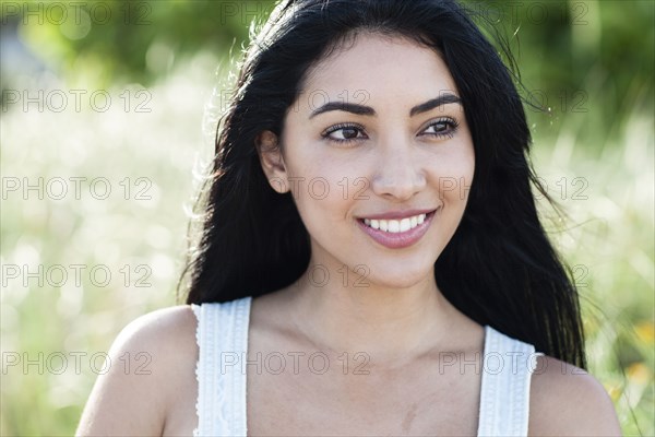 Hispanic woman smiling outdoors