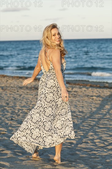 Caucasian woman walking on beach