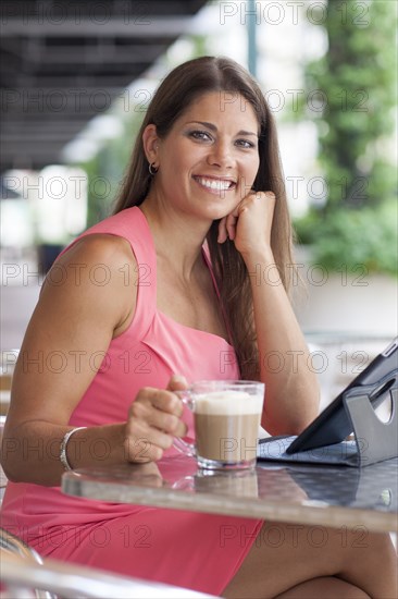 Caucasian woman using digital tablet at cafe