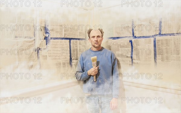 Caucasian man painting himself into corner
