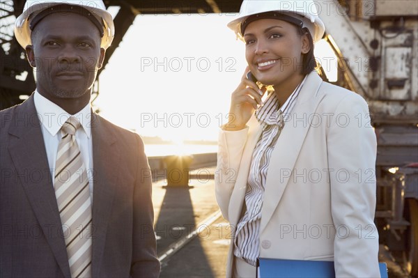 African American businesspeople wearing hardhats