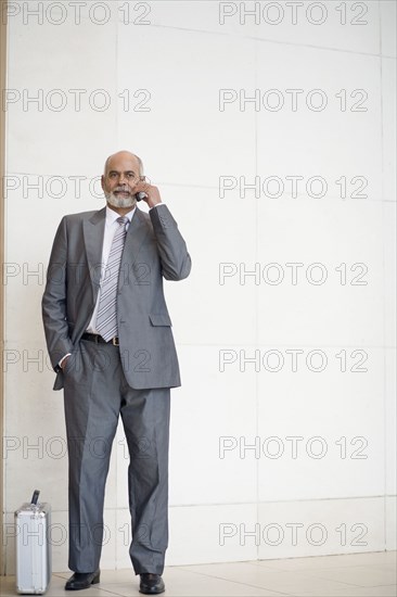 Senior African businessman talking on cell phone