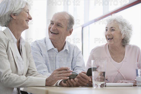 Senior Caucasian friends laughing in cafe