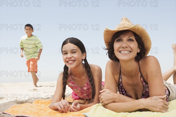 Mother and children relaxing on beach