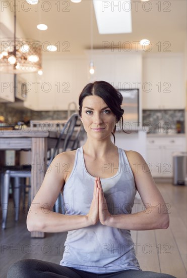 Caucasian woman performing yoga and meditating