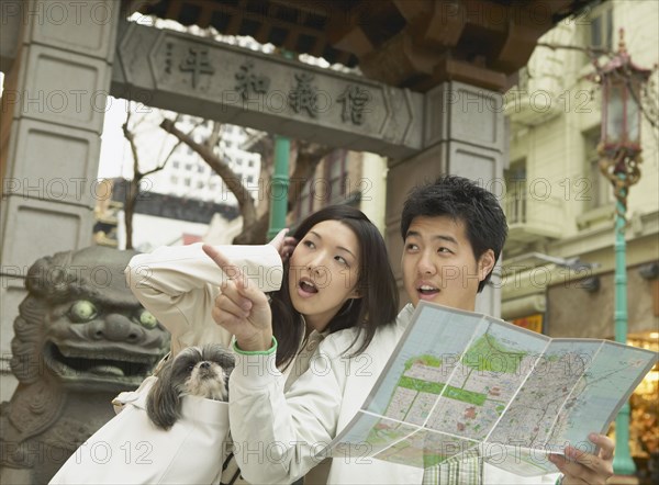 Young Asian couple looking at a map