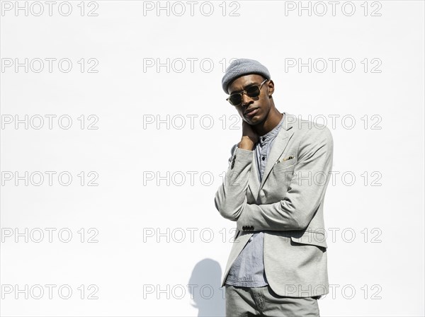 Portrait of pensive Black man wearing sunglasses