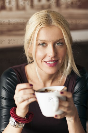 Woman drinking cup of coffee