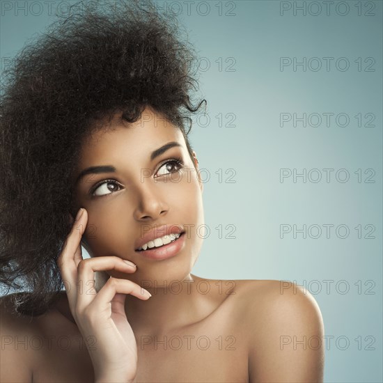 Close up of woman with curly hair thinking