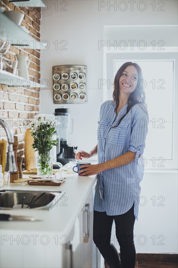 Caucasian woman smiling in kitchen