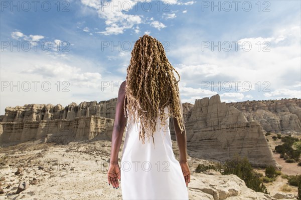 African American woman examining rock formations