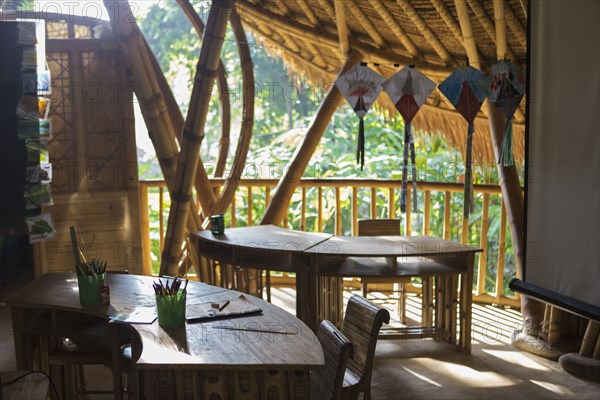 Desks and chairs on bamboo patio classroom