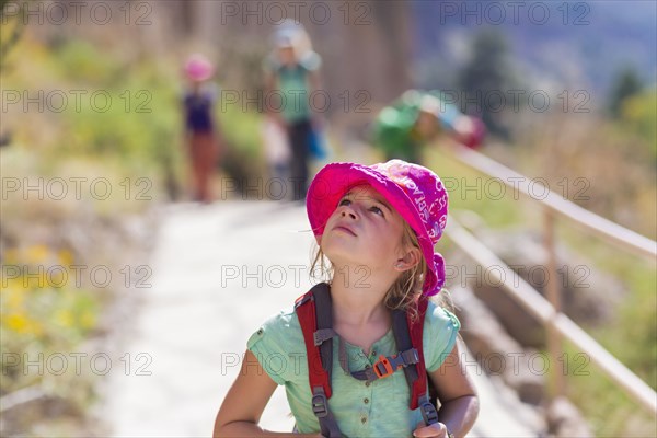 Caucasian girl hiking on rocky mountainside