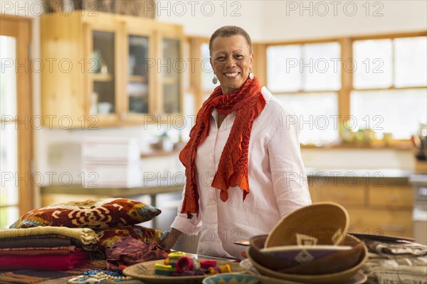 Older mixed race woman smiling in home office