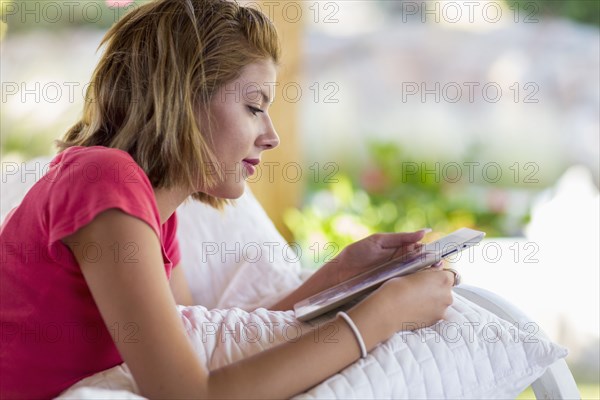 Mixed race woman using digital tablet