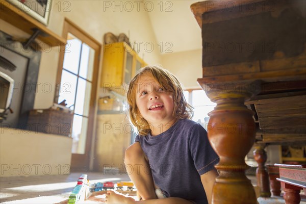 Caucasian boy playing with toy race track on floor