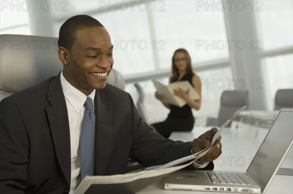 African business man reading newspaper