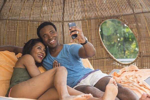 Couple taking selfie in cabana