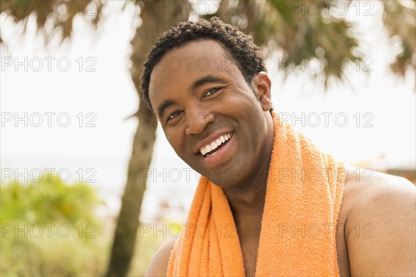 Black man smiling on beach