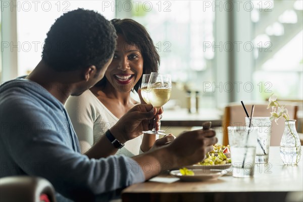 Couple drinking wine at lunch in cafe