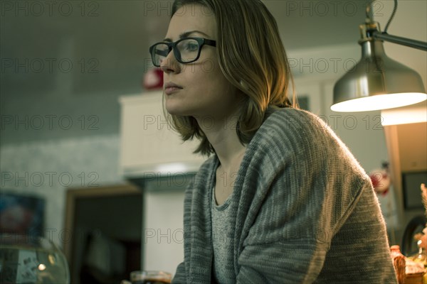 Serious Caucasian woman sitting indoors