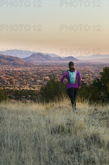 Hispanic woman running in remote area