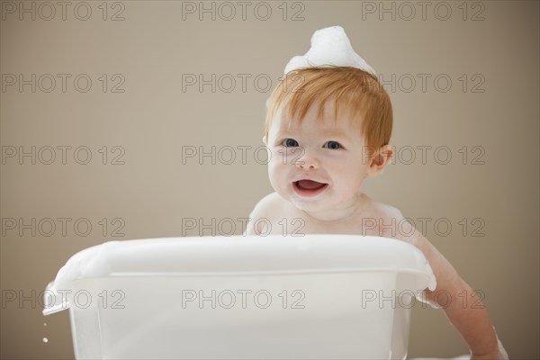 Caucasian baby girl having a bath