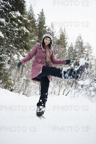 Caucasian woman playing in the snow