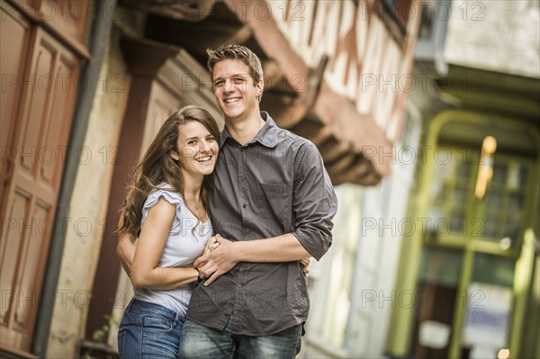 Caucasian couple hugging in village