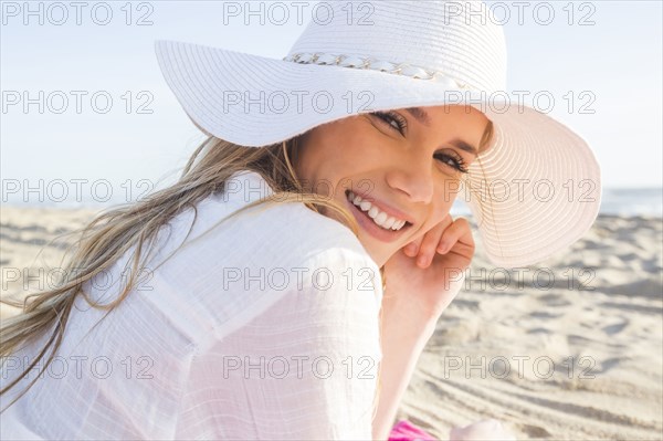 Caucasian woman laying on beach